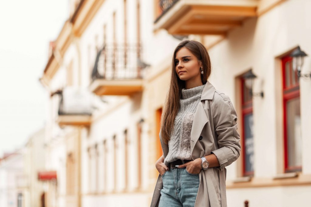 woman posing for a photo with her cashmere sweater and long coat