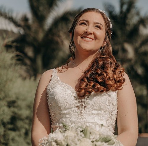 Curvy woman in a white wedding dress with brown hair