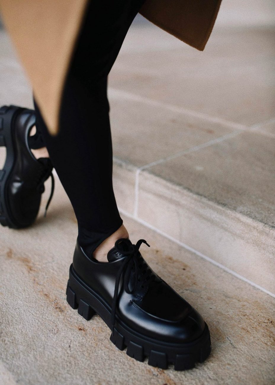 Black lace-up chunky loafers worn with black pants