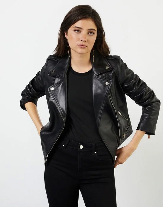 Black leather biker jacket worn by a brunette woman