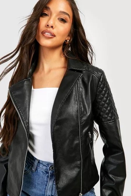 Brunette woman wearing a black faux leather jacket