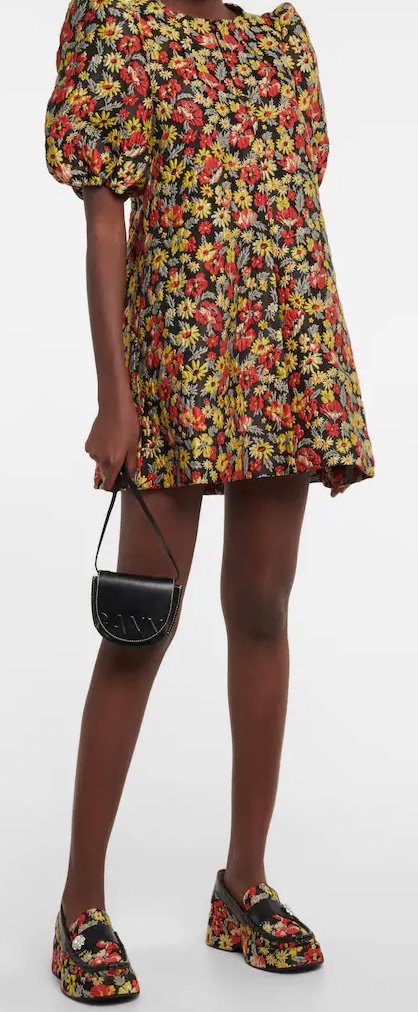 Floral platform loafers worn with a floral dress and a small black bag