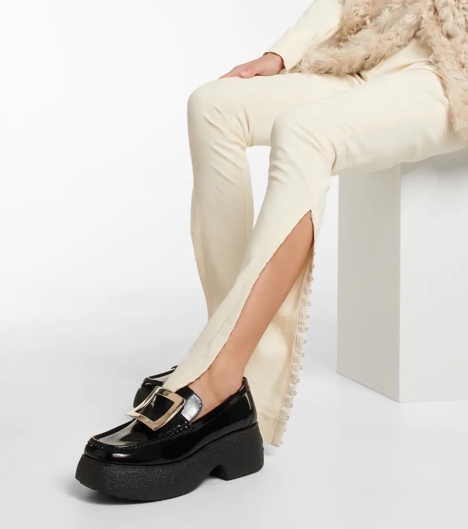 Very beautiful pair of platform leather loafers worn by a woman