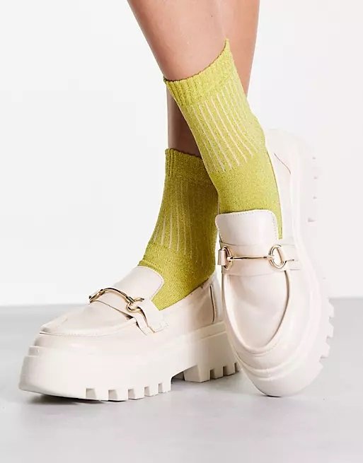 Woman wearing off-white chunky loafers