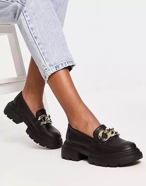 Black chunky loafers with gold bits worn with jeans