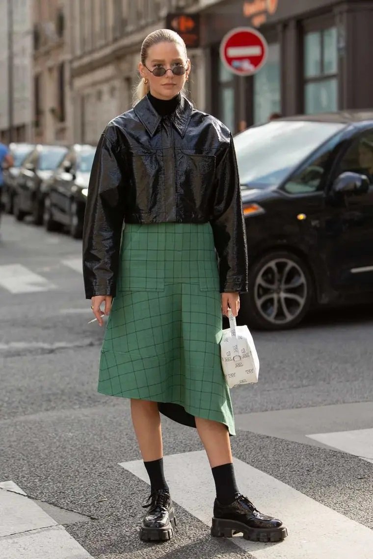 Black lace-up chunky loafers worn with a skirt and jacket