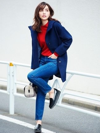 Woman wearing black platform loafers with jeans and a t-shirt