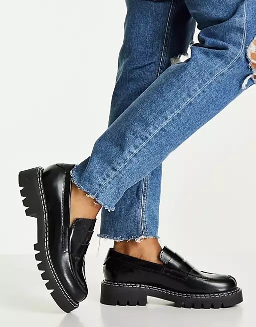 Black leather women's loafers worn with jeans