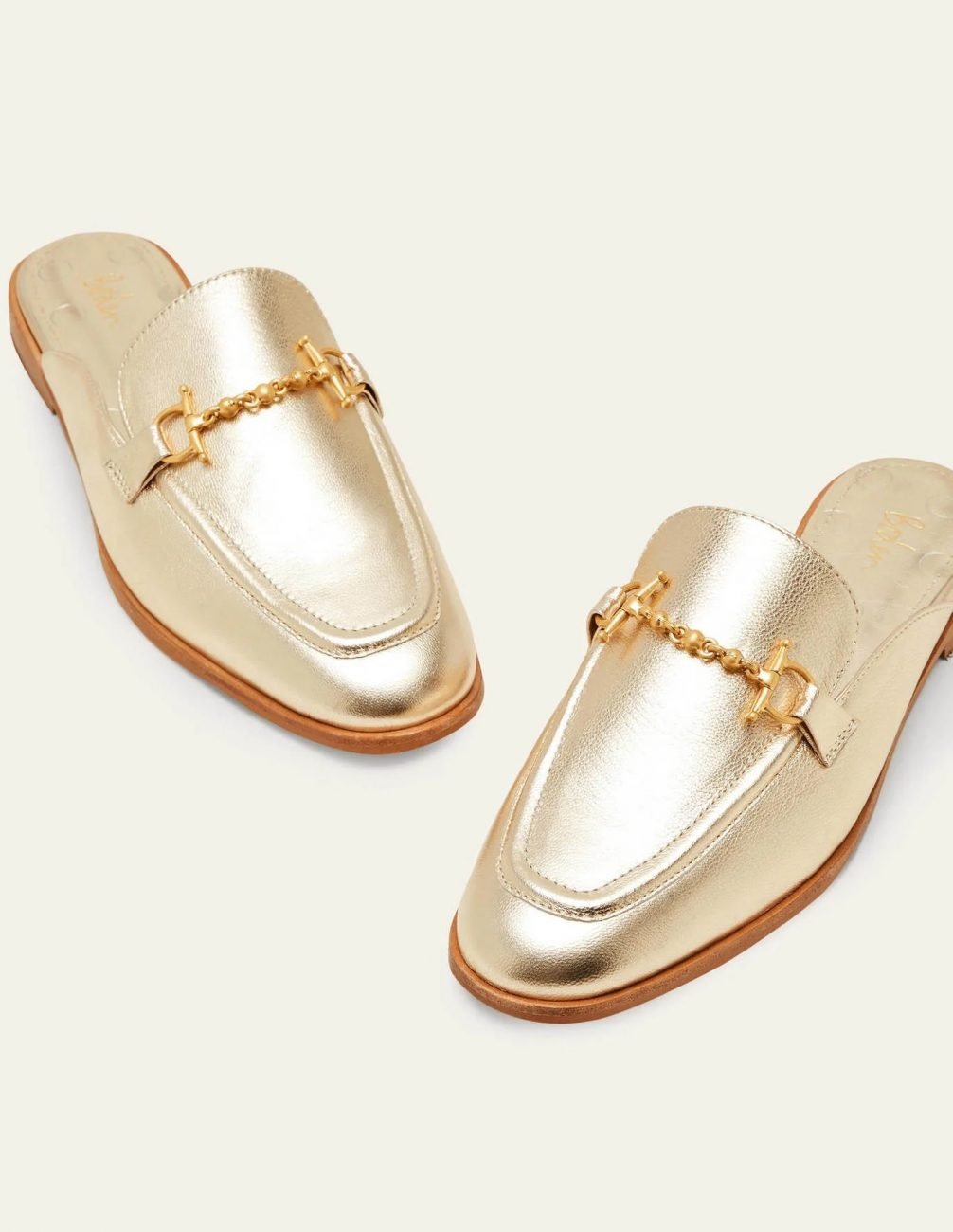 Metallic gold open loafers with decorative gold bits