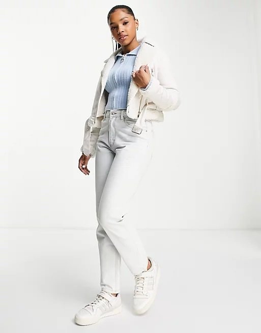 Very beautiful woman wearing a short white aviator jacket