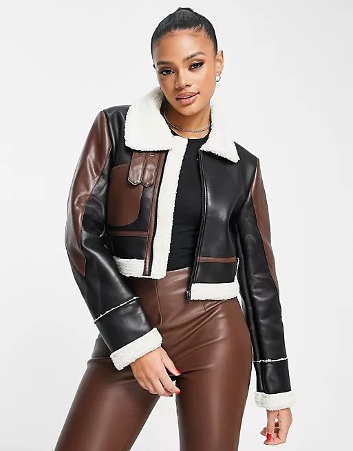 Lovely woman wearing a short brown aviator jacket