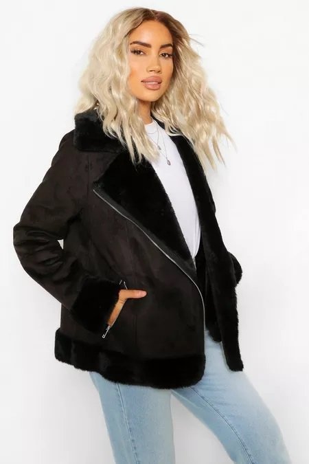 Blonde woman wearing a black suedette aviator jacket