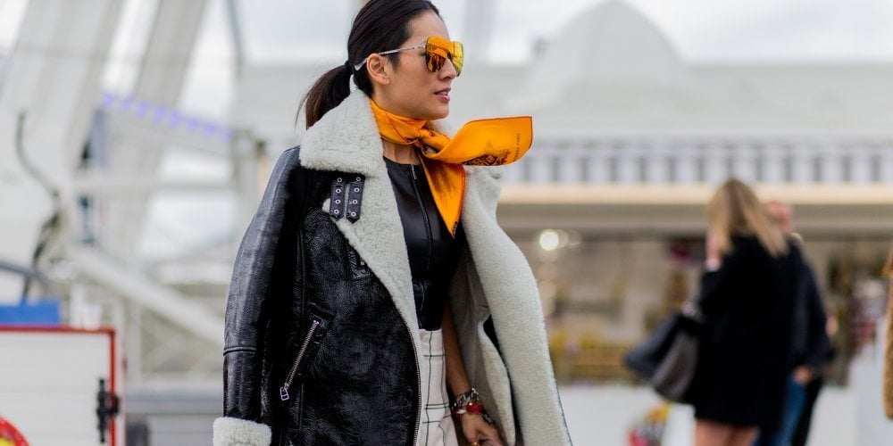 Woman wearing an aviator jacket with glasses