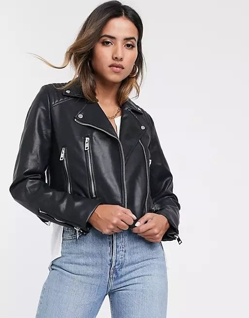 Woman wearing a black faux leather jacket