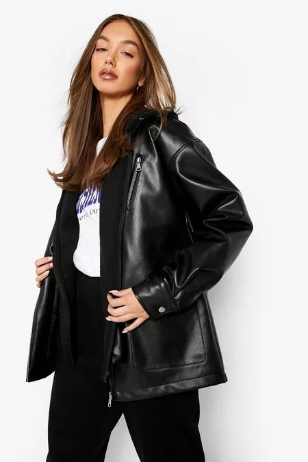 Woman wearing an oversized black faux leather jacket