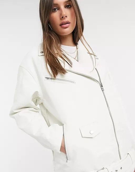 Woman in a total white look with a white faux leather jacket