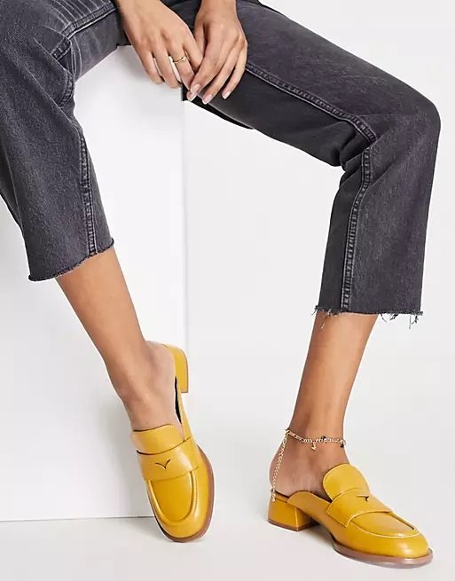 Woman wearing mustard-colored mule loafers