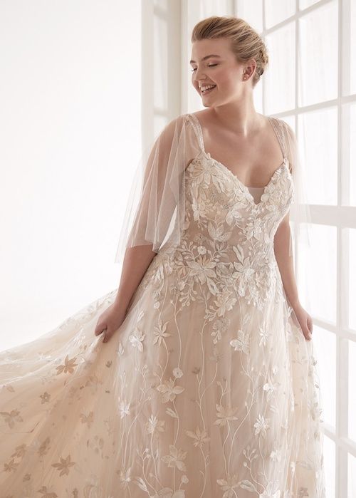 Lace wedding dress with sleeves worn by a curvy woman