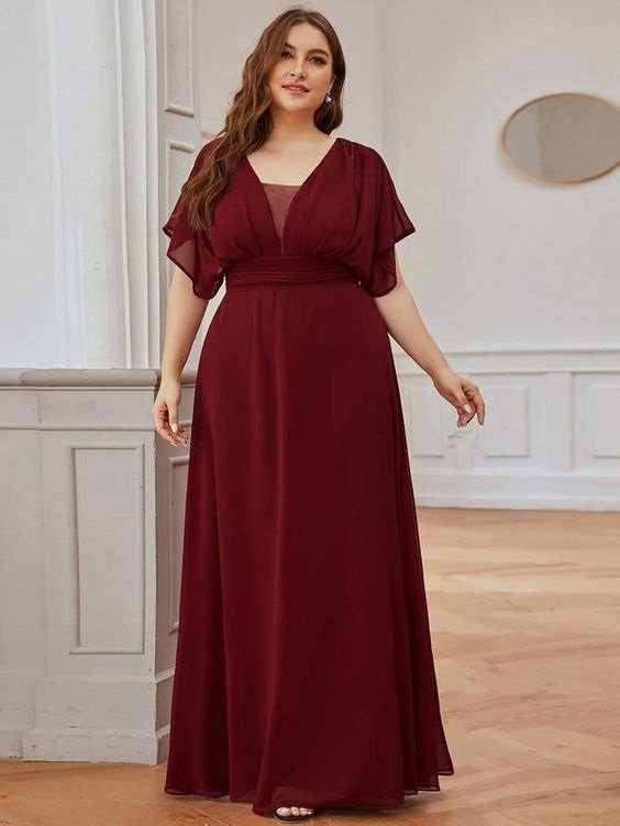 Curvy woman wearing a long burgundy empire dress