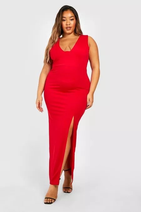 Elegant curvy woman in a fitted long slit dress