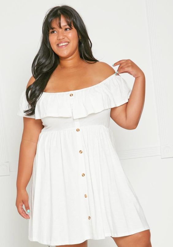 Curvy woman wearing a short white dress with off-shoulder