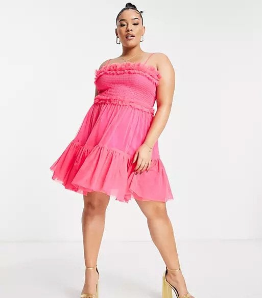 Curvy woman wearing a short pink trapeze dress