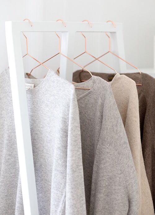 cashmere sweaters hanging with hangers