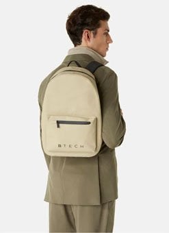 Man carrying a designer waterproof men's backpack in sand color