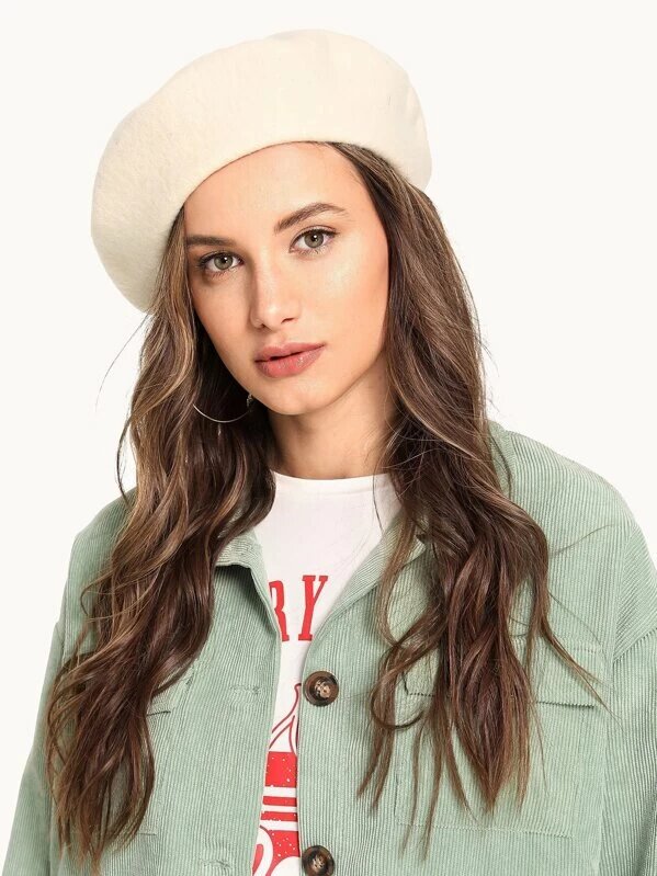 A woman wearing a solid color beret from Shein