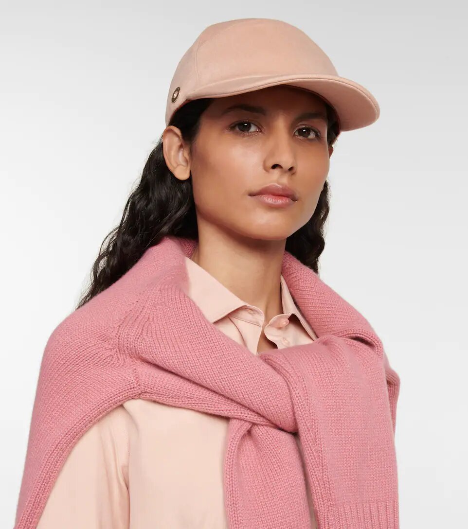 Woman wearing a pink cashmere cap from Loro Piana