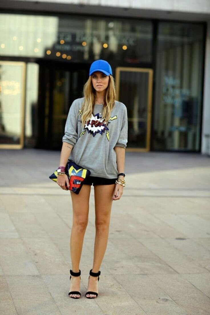 A woman wearing a blue snapback cap