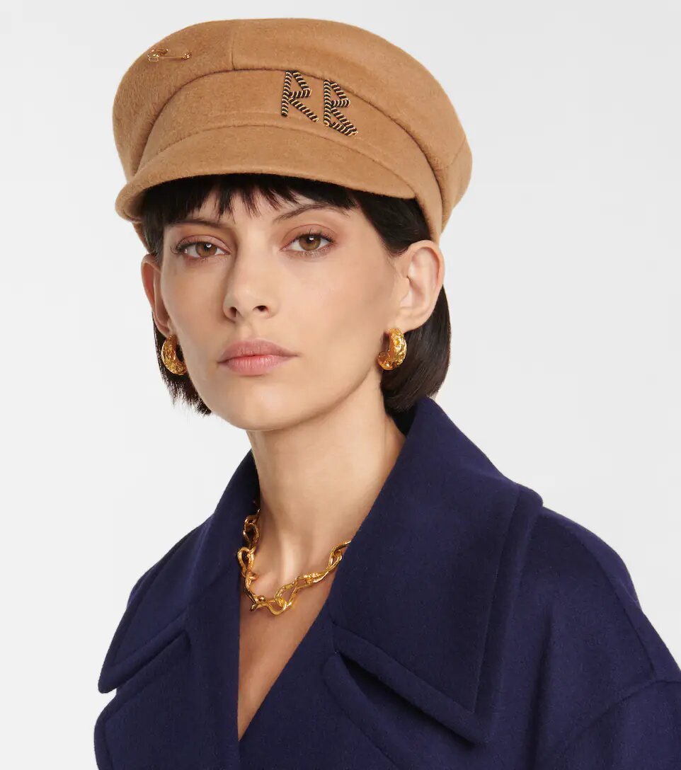 Beautiful brunette wearing a brown embroidered newsboy cap in wool