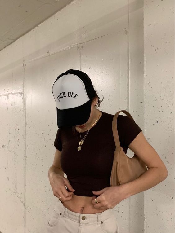 Casual look of a woman with a black and white trucker cap