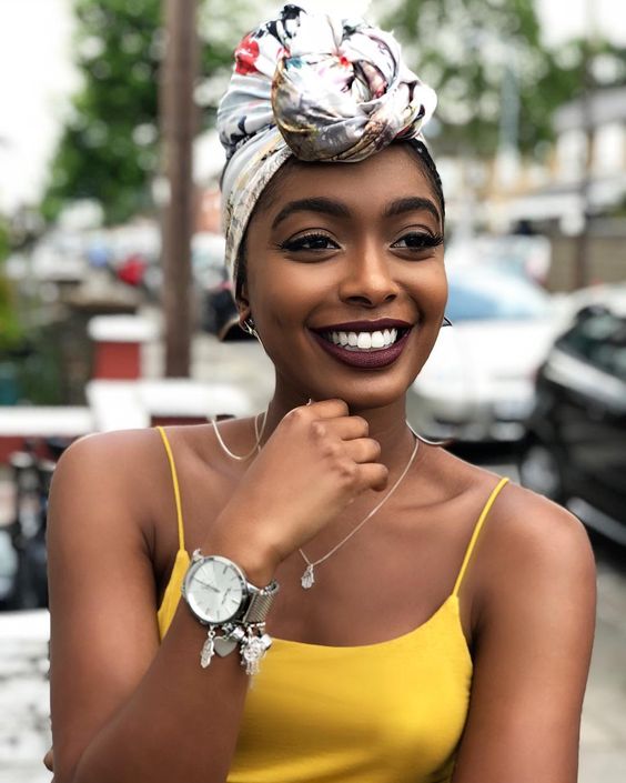 Woman with dark skin wearing a silver watch