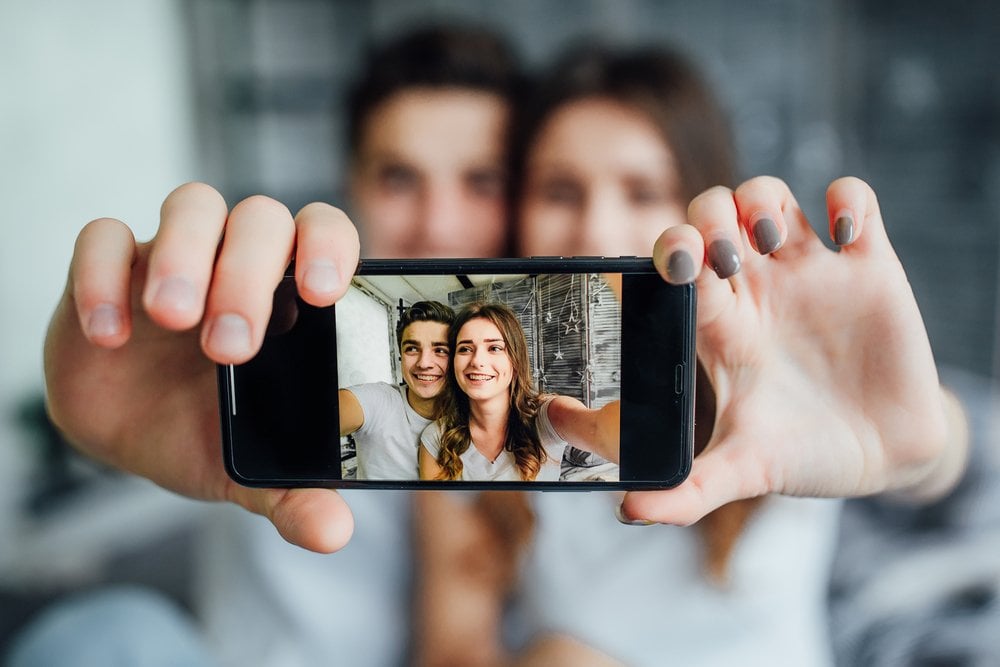 A couple taking a selfie on a phone