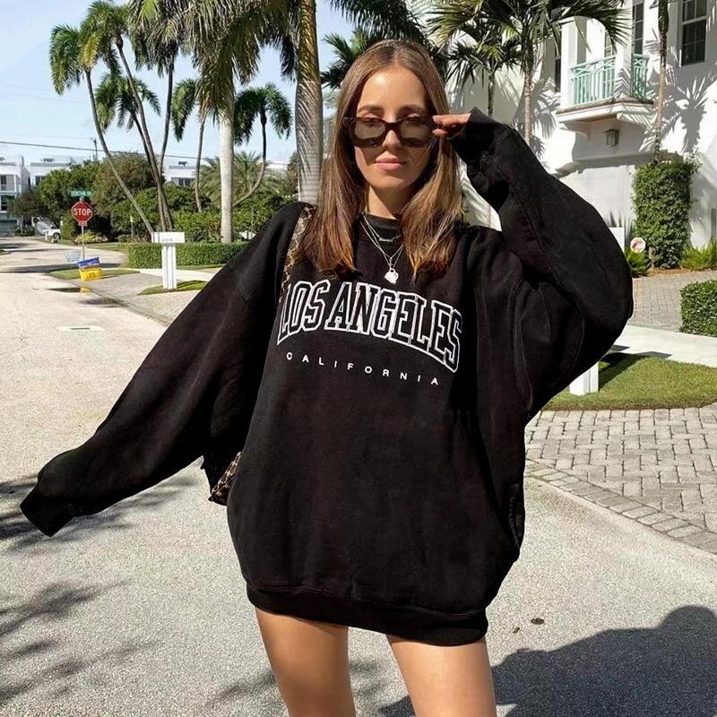 Woman wearing an oversized black sweatshirt