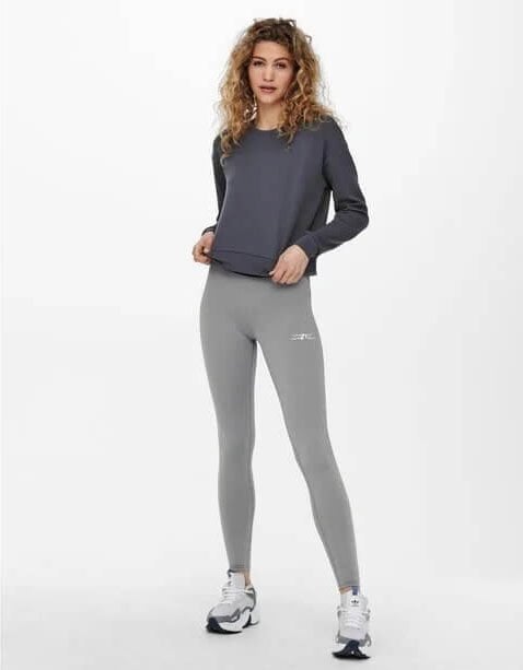 Very beautiful woman wearing a sweatshirt and gray leggings