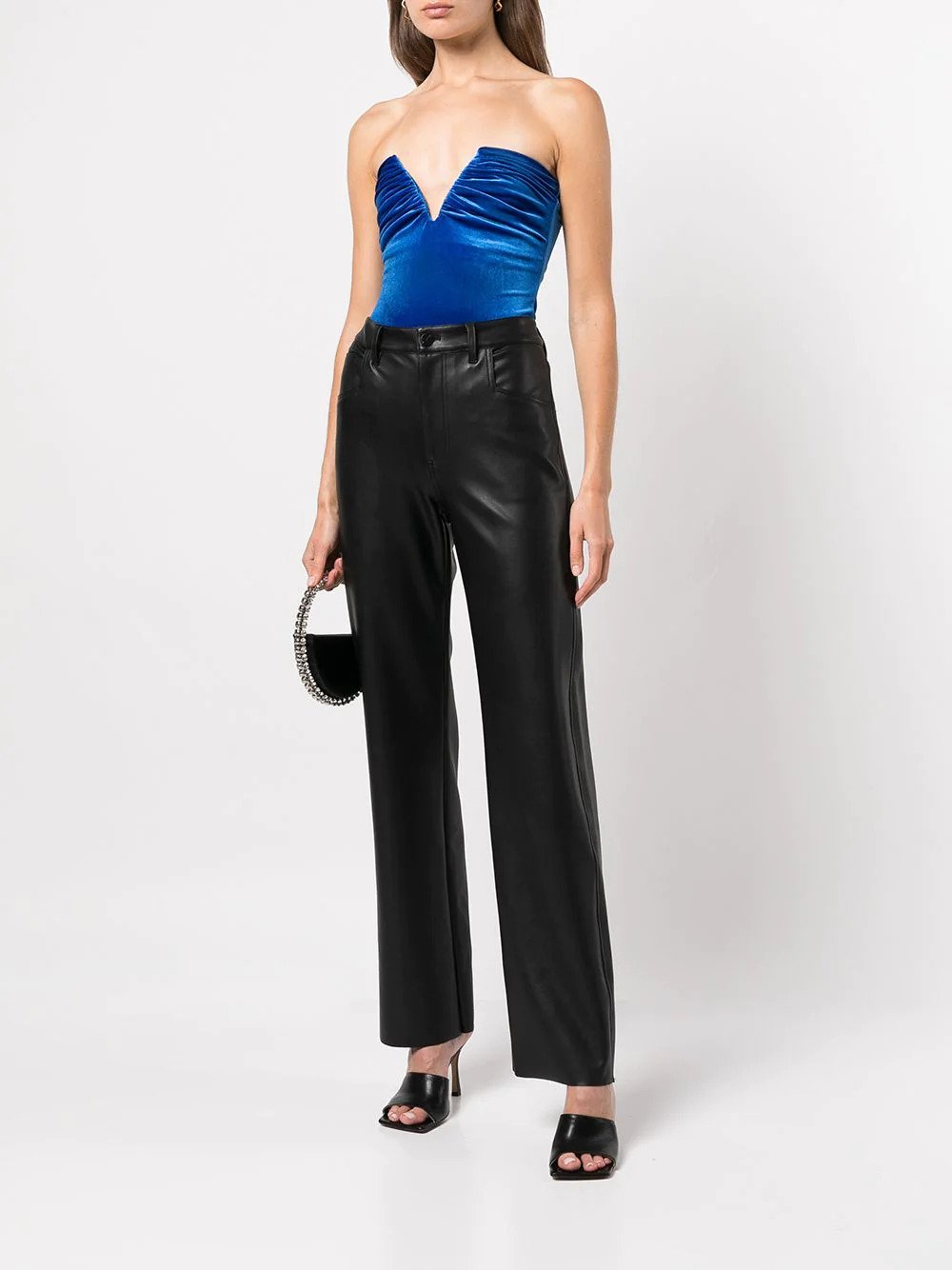 woman in a blue bustier bodysuit and leather pants