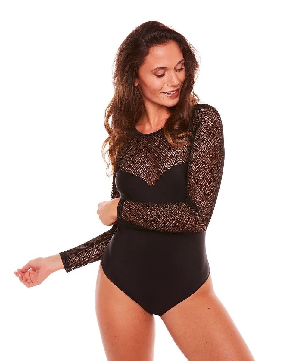 woman in a long-sleeve sheer black bodysuit