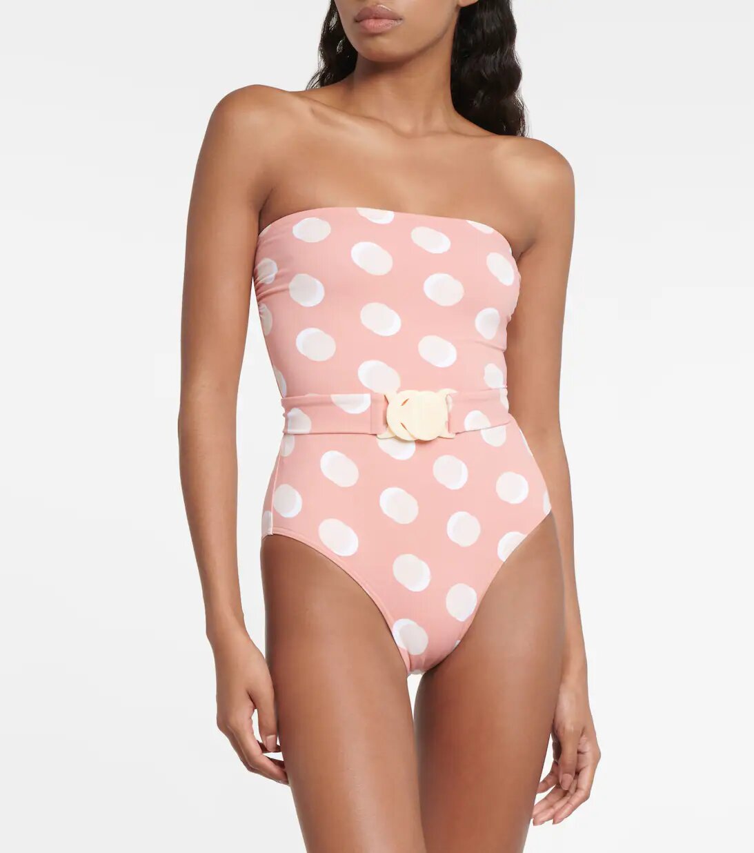 White polka dot bandeau swimsuit on pink background Eres